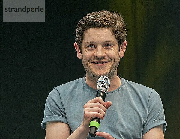 STUTTGART  GERMANY  JUN 29th 2019: Iwan Rheon (*1985  Welsh actor  singer and musician) talks about his experiences in the movie industry at Comic Con Germany Stuttgart  a two day fan convention