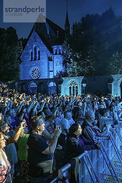 Crowd at night concert in front of a church  many holding up mobile phones  blue lighting  Klostersommer  Calw Hirsau  Black Forest  Germany  Europe