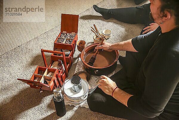 A shaman prepares ceremonial cocoa for healing and spiritual connection