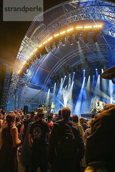 Crowd at a night concert in front of a blue illuminated stage  Klostersommer  Calw Hirsau  Black Forest  Germany  Europe