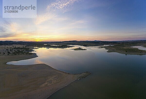 Drone aerial panorama of a dam lake reservoir at sunset in Terena  Portugal  Europe