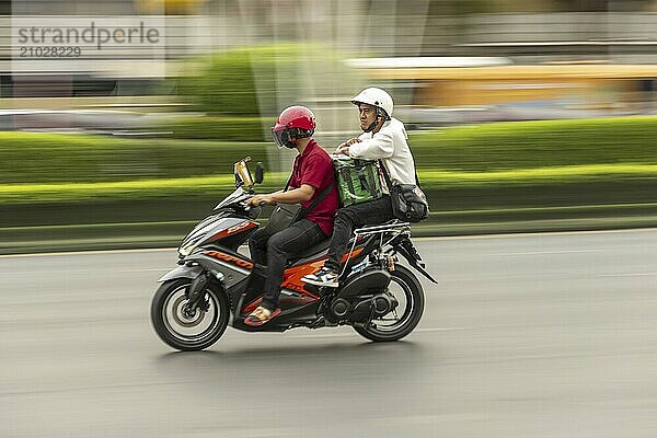 Two men on a moving motorbike  Radchadamnoen Klang Road  Phra Nakhon  Bangkok  Thailand  Asia