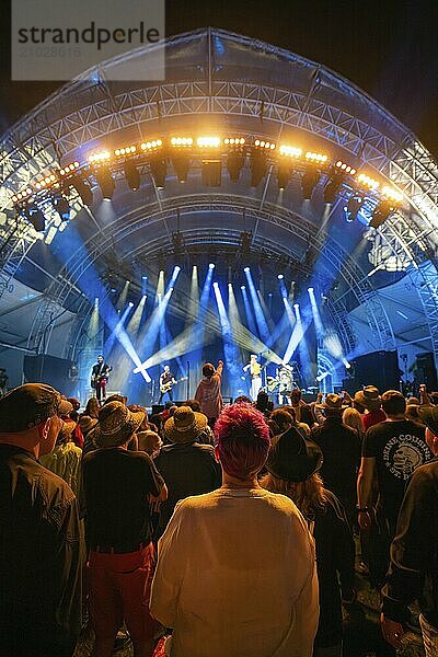 Crowd at a night concert with intense blue lights on stage  Klostersommer  Calw Hirsau  Black Forest  Germany  Europe