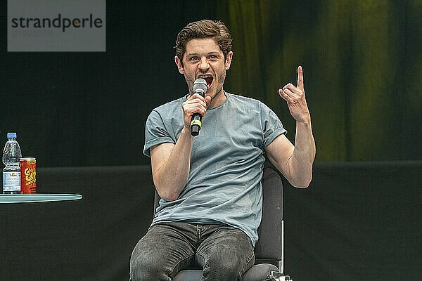 STUTTGART  GERMANY  JUN 29th 2019: Iwan Rheon (*1985  Welsh actor  singer and musician) talks about his experiences in the movie industry at Comic Con Germany Stuttgart  a two day fan convention