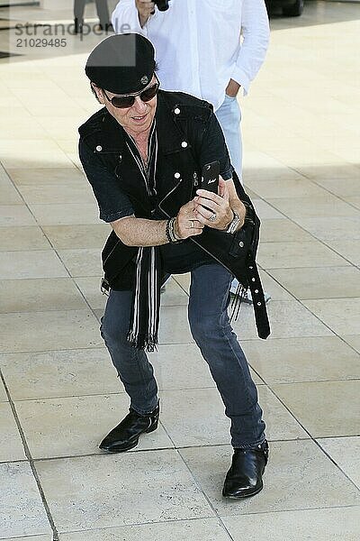 Drummer Mikkey Dee of the hard rock band Scorpions receives a yellow Lamborghini in front of a concert in the Principality of Monaco  Klaus Meine photographs the car