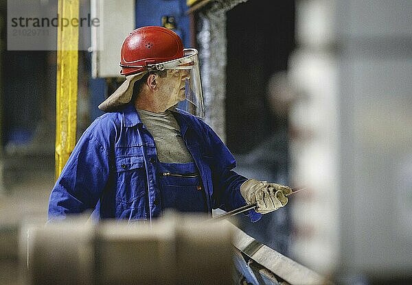 A worker stands at a boiler during a galvanising process. Taken during a press event at The Coatinc Company in Siegen  22/08/2024