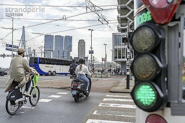 Bicycle traffic light  cyclist on cycle path  in front of the Erasmus Bridge over the Nieuwe Maas  skyline of skyscrapers on the Kop van Zuid  Rotterdam  Netherlands