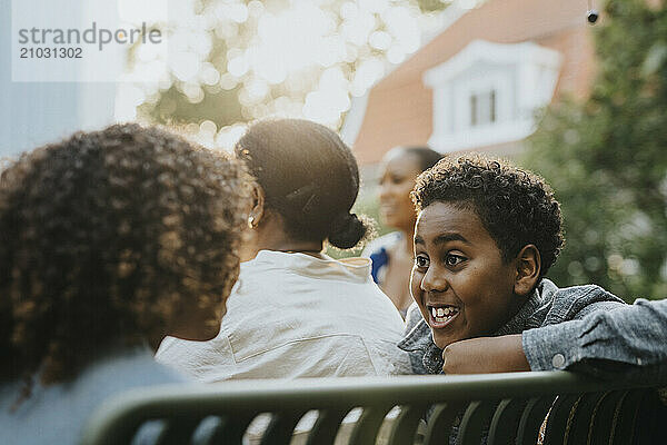 Excited boy discussing with sister during social gathering