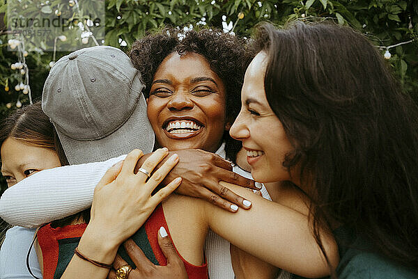 Cheerful woman greeting friends at dinner party