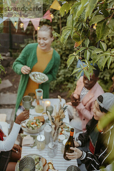 High angle view of leaves with friends partying in back yard