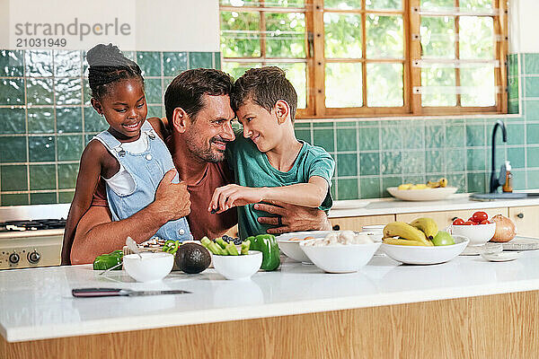 Father embracing children (6-7  8-9) in kitchen