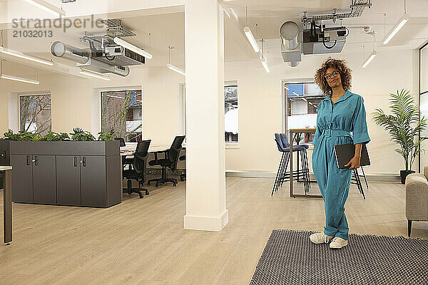 Smiling woman standing in creative studio