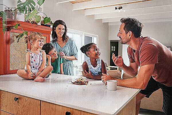 Parents with children (18 - 23 months  6-7  8-9) in kitchen