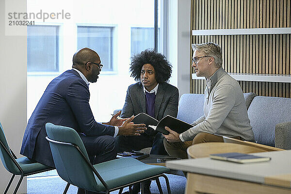 Businessmen talking in office