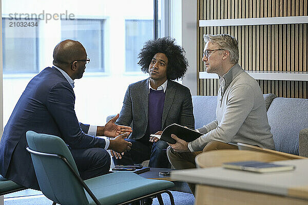 Businessmen talking in office