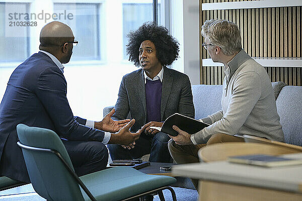 Businessmen talking in office