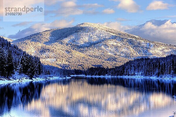 The reflection of a snow covered mountain on the Pend Oreille River in Eastern Washington