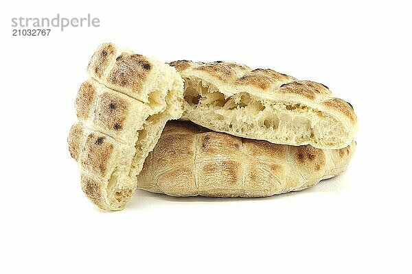 Stack of round pita flat-breads isolated on a white background  pita bread has a pocket and is cut open  showcasing their soft interior