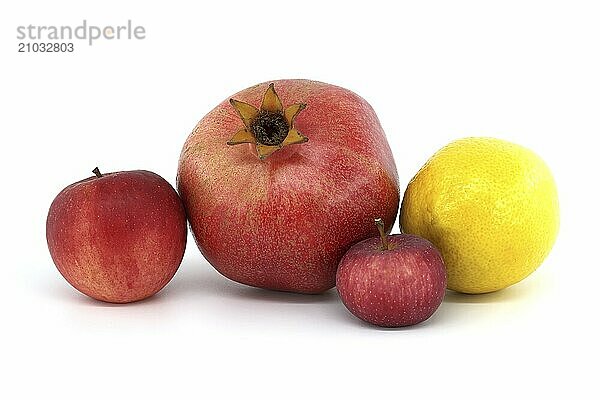 Fresh ripe pomegranate  red apples and whole yellow lemon isolated on white background