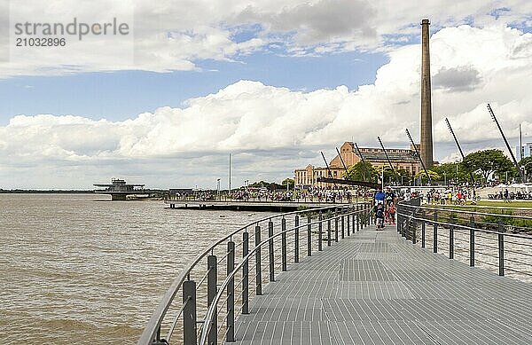 PORTO ALEGRE  BRAZIL  december 23  2018: People enjoying a sunny day in the revitalized Guaiba waterfront next to Usina do Gasometro  an old power plant in Porto Alegre  southern Brazil