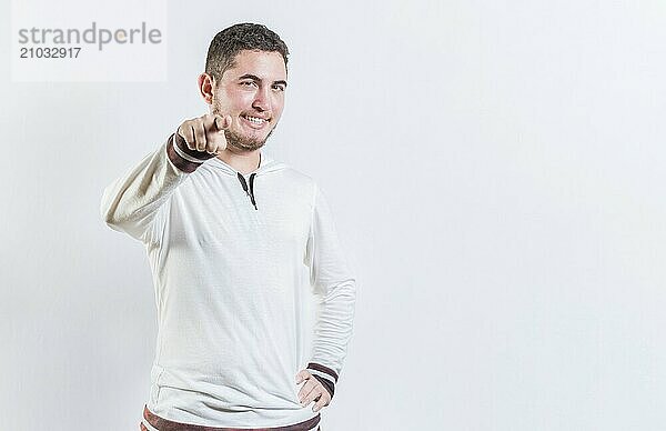 Happy teenage guy pointing at you on isolated background. Attractive cool guy pointing at the camera isolated