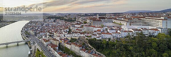 Coimbra panorama drone aerial city view at sunset with Mondego river and beautiful historic buildings  in Portugal