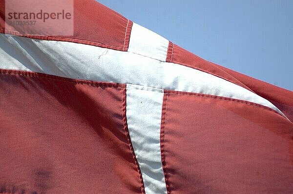 The flag of Denmark against blue sky