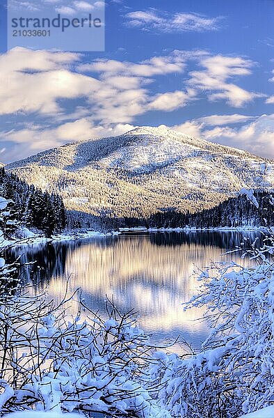 The reflection of a snow covered mountain on the Pend Oreille River in Eastern Washington