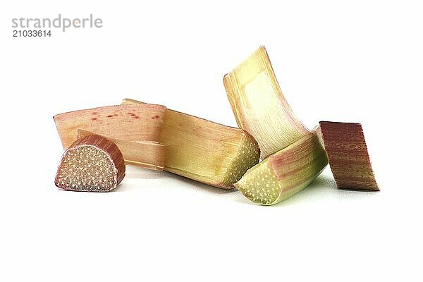 Rhubarb stalks of varying colors from pale green to deep red isolated on white background  illustrate a recipe for a rhubarb-based dish