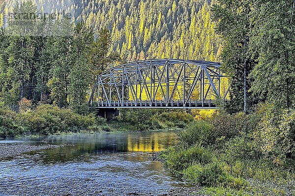 A small automobile bridge spans over a small section of the Coeur d'Alene river in north Idaho