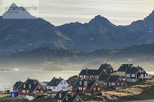 Typical Greenlandic houses on a fjord with steep mountains  Inuit settlement  autumn  Tasiilaq  East Greenland  Greenland  North America