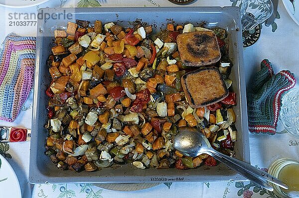 Mixed vegetables with fried cheese on a baking tray  Bavaria  Germany  Europe