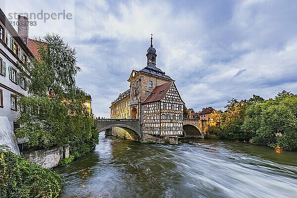 Old Town Hall on an artificial island in the River Regnitz. The landmark can be reached via two arched bridges. Night shot. City view of Bamberg  Upper Franconia  Bavaria  Germany  Europe