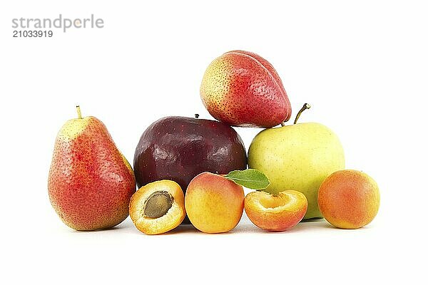 Whole and halved ripe apricots  multicolored pear  red and green apples isolated on a white background. Multivitamin and juicy rich fruit