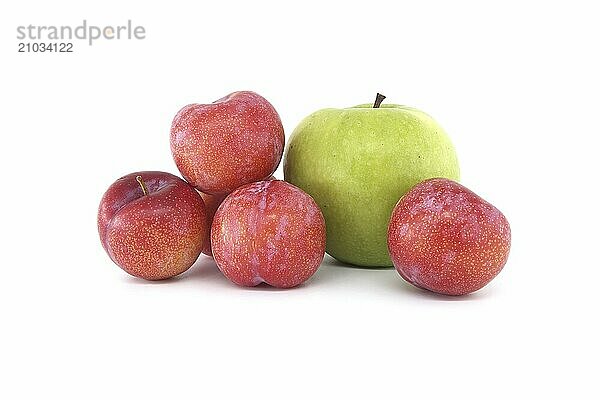 Collection of fresh fruits comprising red plums and bright green apple arranged against a white background