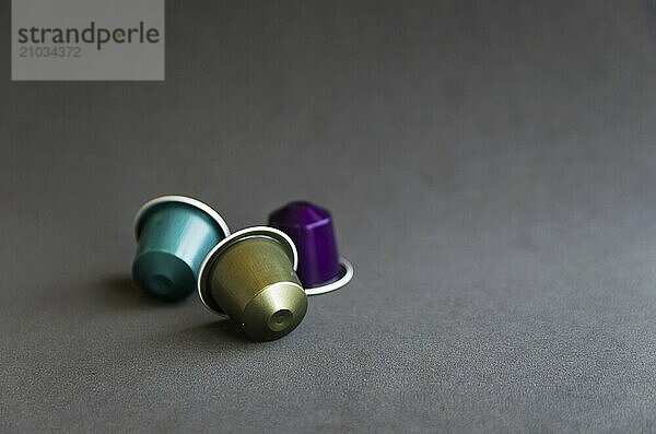 Beautiful colored coffee capsules on black background