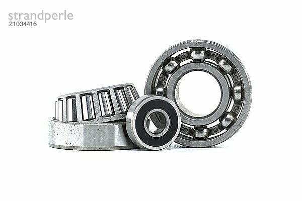 Ball bearings and tapered roller bearing isolated on white background. Car bearings  auto parts  automobile components for the engine and chassis suspension