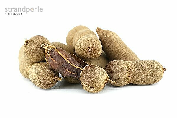 Pile of fresh whole tamarinds fruits isolated on white background