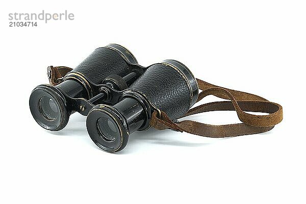 A pair of antique black binoculars with brown leather straps is showcased against a white background