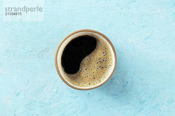 Coffee cup  overhead flat lay shot on a blue background  espresso drink  Food photography