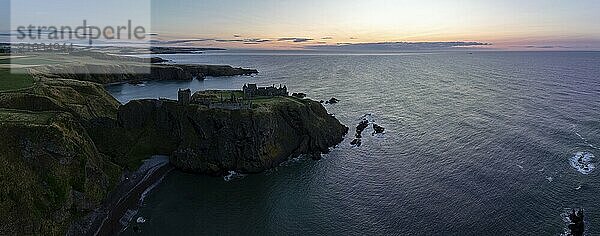 Dunnottar Castle  castle ruins at sunrise on the cliffs  drone shot  Stonehaven  Aberdeenshire  Scotland  Great Britain