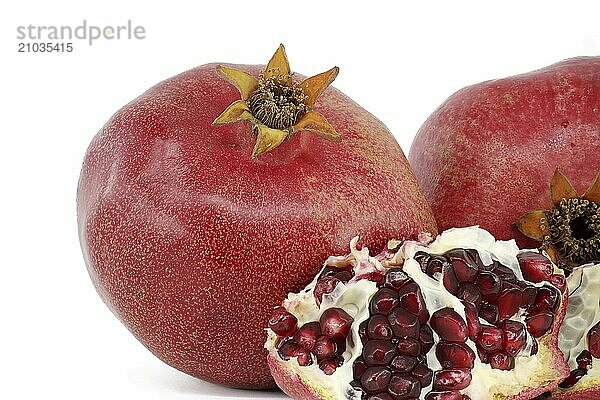 Red juice pomegranate fruits isolated on white background