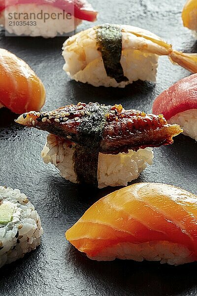 Sushi. Nigiri with eel  salmon and shrimp on a black background  Japanese food on a plate at an Asian restaurant  Food photography