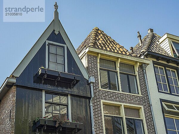 Three historic houses with eye-catching gables and large windows in one town  alkmaar  the netherlands