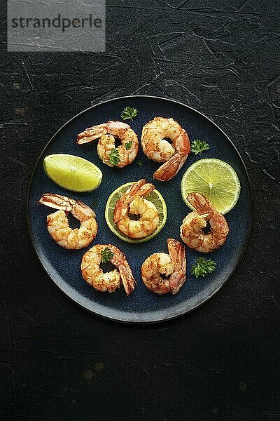 Shrimps  shot from the top on a black background. Cooked shrimp with lime  spicy seafood dish  Food photography  Food photography