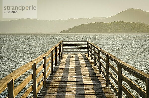 Beautiful wooden dock in pond overlooking mountains  quiet view