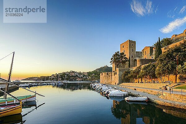 Medieval castle and boats at Collioure city at sunrise at Occitanie in France