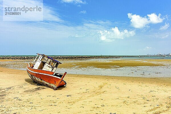 Abandoned and deteriorated fishing trawler stranded on the beach sand in Olinda  Pernambuco