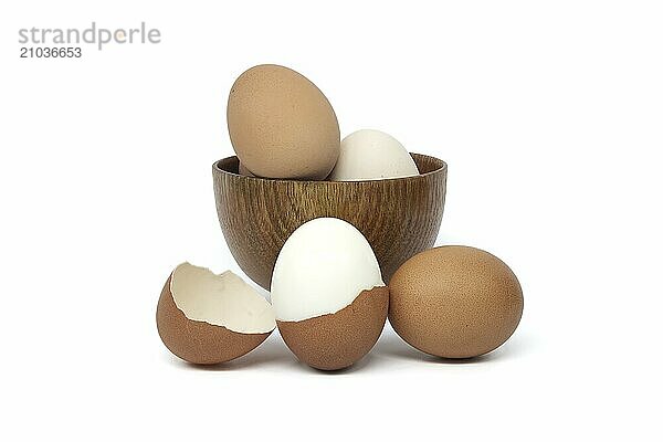 Bowl of eggs with varying colors and detail of the egg shell isolated on white background