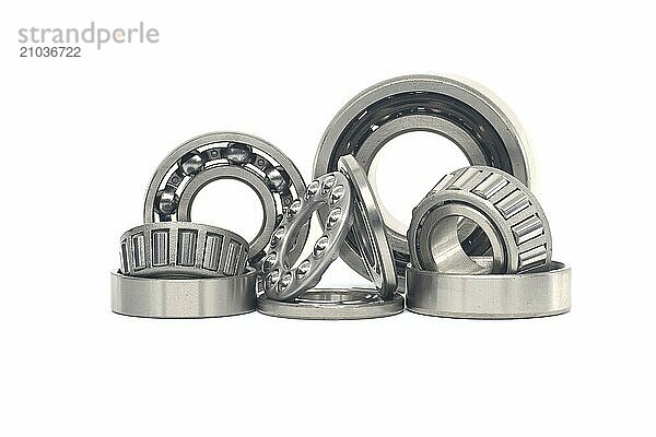 Array of bearings of varying sizes and types  including roller bearings and ball bearings isolated on a white background